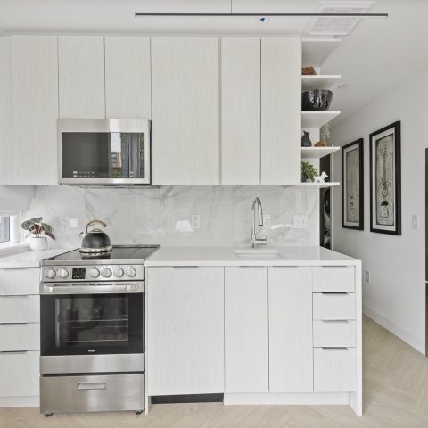 kitchens with sleek appliances and muted wood grain cabinets